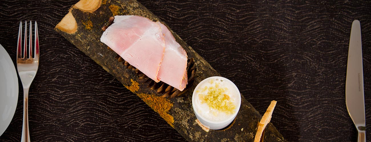 Ham served on a wooden plate