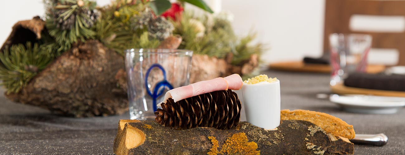 Ham on a pine cone on a piece of wood