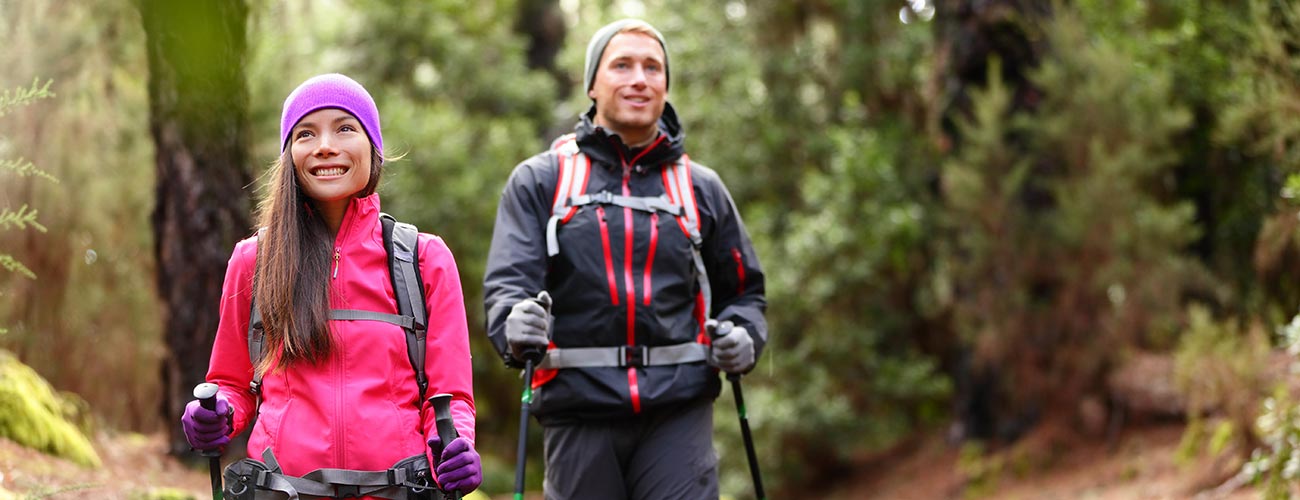 Couple with a technical jacket, caps and gloves trekking